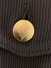 Gold button engraved with "Junior Gaultier". 