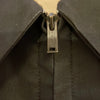 Zoomed in view of Talon zipper-beige and black collar zip-up with patches