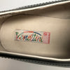 Closeup of "Venettini" label in 1990s black penny loafers