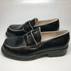 1990s black penny loafers with white trim and chunky soles