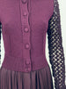 Close up front view of dark purple wool knit top with knit buttons and draped rayon skirt on Jean Paul Gaultier dress.