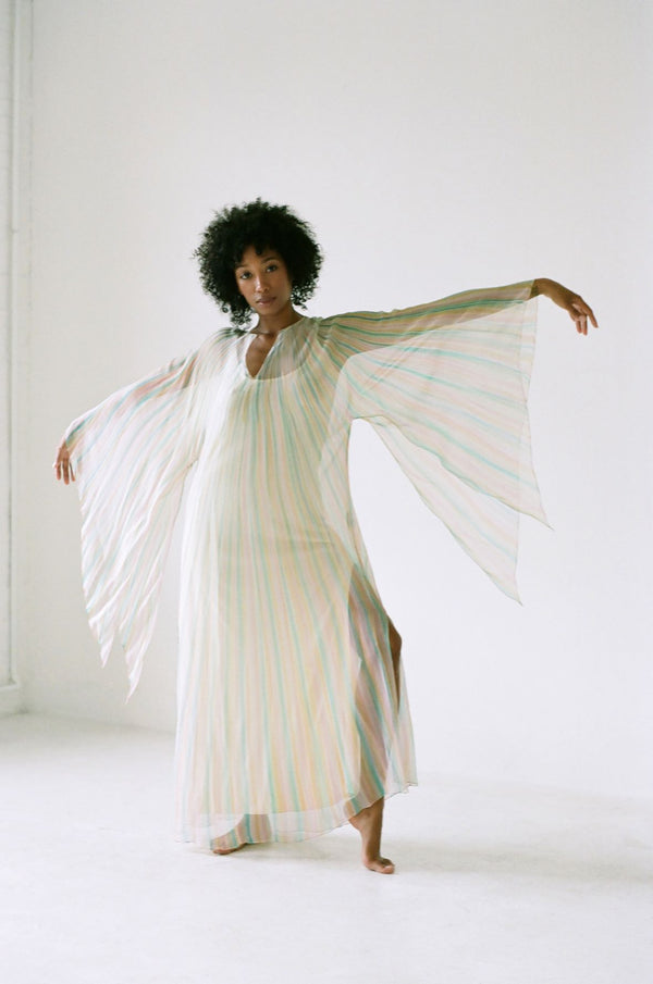 Woman standing with her arms out to the sides wearing a 1970's Halston Kaftan 