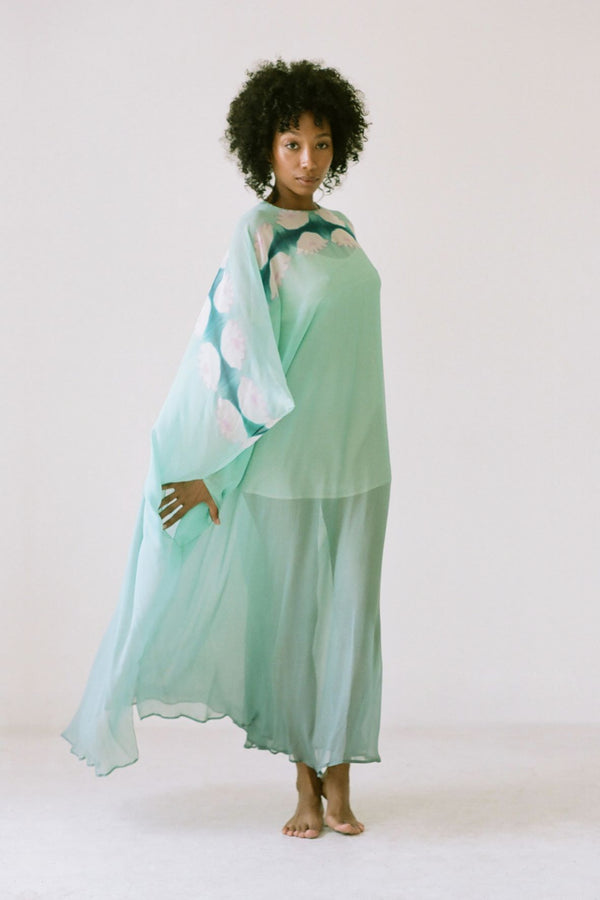 Woman wearing 1970's Halston teal blue Kaftan. 