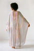 Woman standing backwards in a 1970's Halston Kaftan highlighting hand dyed abstract detailing 
