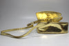 Close up of gold snake shoulder strap and bottom of detachable metallic gold snake Prada bag