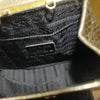 Close up of interior lining of the metallic gold snake Prada evening bag featuring signature Prada stitching and authentic metal Prada plaque