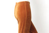 Close up of mannequin waist wearing 1980s gold/orange velvet stirrups with elastic waist