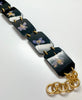 black plastic chain belt with purple flowers pressed inside
