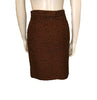  Two piece suit with skirt in burnt orange tweed wool with metallic thread. Jacket is hip length with three quarter sleeves and three button closure. Skirt is straight and knee length