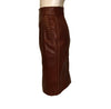 two piece skirt and jacket in burgundy leather Jacket has gold studs on collar and front pockets. Skirt is straight and knee length.