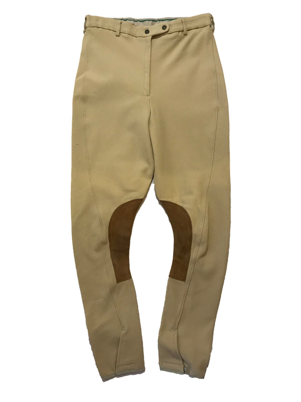 Stretchy, beige breeches with curved seams and brown, suede patches on the inner-knees. 