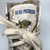 Tongue of white high top sneakers with an all over bug print by Kiki Picasso x Slugger