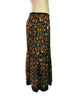 Side view of Easton Pearson silk skirt with a green, orange, and brown gemstone print.