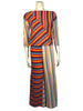 Asymmetrical, multicolor, striped, three-piece set. Three-quarter-sleeve shirt with vertical and diagonal stripes. Wide-leg pants with vertical and horizontal striped legs. Coordinating striped bonnet. 