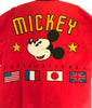 Appliques on a red blazer featuring Mickey Mouse's face and text reading "MICKEY INTERNATIONAL" with flags underneath