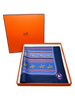 Blue scarf with horse sequences print in orange Hermes box.