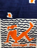 Closeup of Courreges abstract oblong scarf with a woman lounging in front of waves