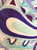 Close up of Emilio stamp on swirly pattern