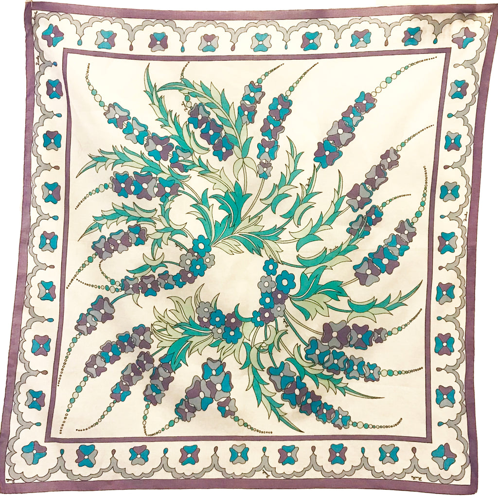 16 by 16 inch cream Emilio Pucci cotton scarf with purple grey and blue strings of flowers intertwined with green leafy vines bordered by a line of purple and blue flowers in between two purple lines