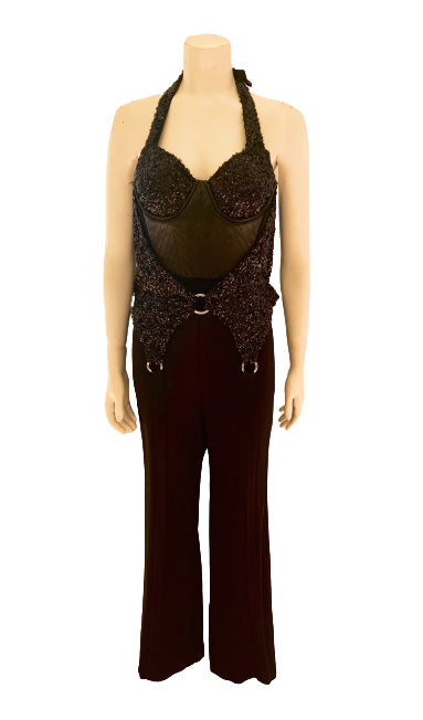 Black, halter-neck, jumpsuit with black, sequin bra-cups and garter-belt that is hooked to silver o-rings. Attached vegan-leather underbust. 
