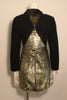Full length back view of mannequin wearing Geoffrey Beene black wool mini dress with gold metallic quilted back panel. 