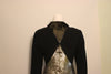 Close up on shoulders of mannequin wearing Geoffrey Beene black wool mini dress with gold metallic quilted back panel. 