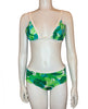 Green and white leaf print bikini shown on a mannequin form