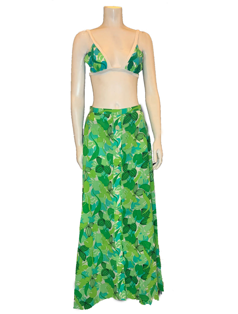 Bikini top and maxi skirt in a green and white leaf print shown on a mannequin.