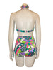 1960s women's bikini in a psychedelic lime green, aqua, lavender, and white print shown on a  mannequin form