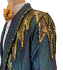 Teal tailcoat with lightning bolts in sequins, studs, and rhinestones on one shoulder & cuff.