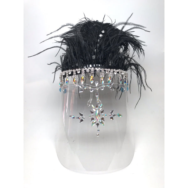 An embellished face shield with rhinestones and black feathers at the top