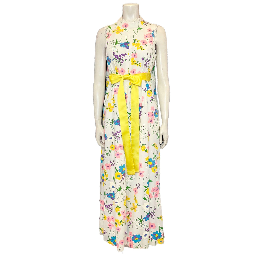 White and multicolor floral maxi dress with yellow belt.