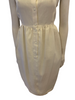 White, linen, sleeveless, knee-length, button-down dress with a cutout-back. 