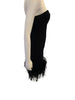 Black, strapless, form-fitting, evening dress with feather-trimmed hem. Knee length.