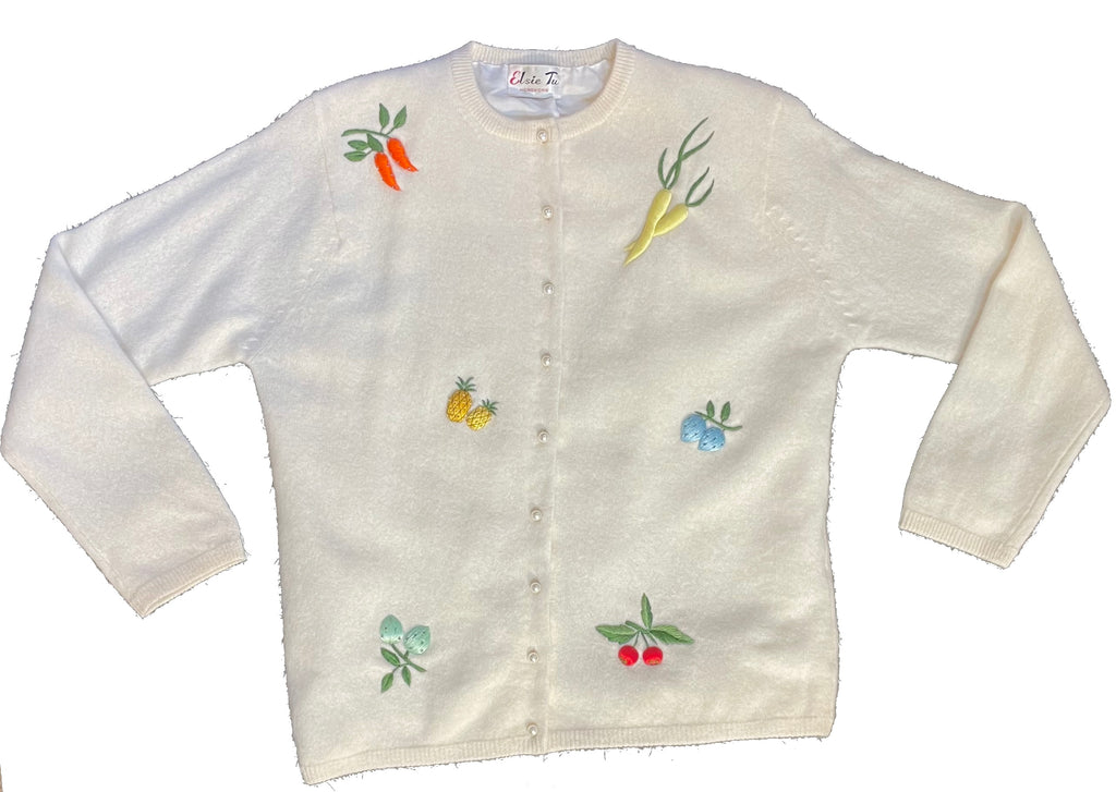 A creme knit cardigan with fruit and vegetable embroidery
