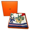 White and multicolor scarf with floral print in orange Hermes box.