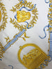 Closeup of Mulberry Silk scarf with golden panthers, books, and mountains intertwined with a blue gingham ribbon motif