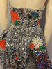 Silver paillette, fit & flare, sleeveless dress with blue, red, green, & white, round, rhinestone appliques. Silver, pleated underskirt. 