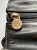 Black leather Fendi handbag with stitched leather body in a wavy pattern. The handles and hardware are in gold-tone metal and chain.
