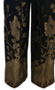 Black-and-gold, silk, brocade, high-waisted pant with floral motif on front top and on legs.