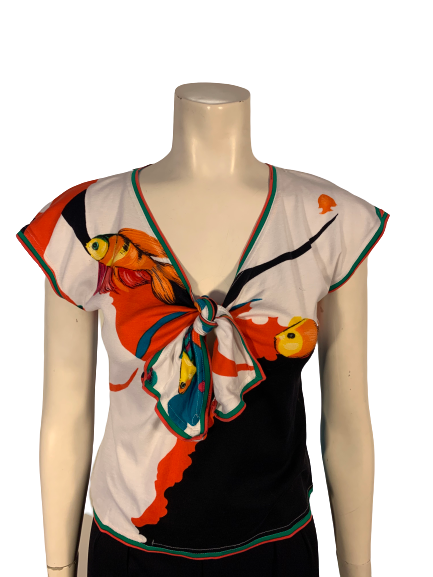 Short-sleeve, v-neck shirt with an all-over fish print in blue, green, black, white, orange, and red. 