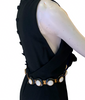 Black, heavy-linen, sleeveless, knee-length dress with an attached white, gold, and black beaded belt. 