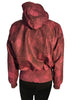 Magenta and black abstract patterned ski jacket. Asymmetrical snap front and high zip up neck. Banded bottom