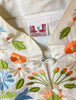 White and multicolor floral embroidered jacket.