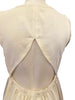 White, linen, sleeveless, knee-length, button-down dress with a triangular, cutout-back.