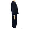 Navy, wool, two-piece skirt suit. Jacket is boxy and hip length with three buttons. Skirt is straight and midcalf length
