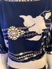 Navy, long-sleeve shirt with white and gold, chain and flower print. Ribbed bands at the sleeves and waist.