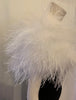 Shoulder shrug in white feathers lays across shoulders 