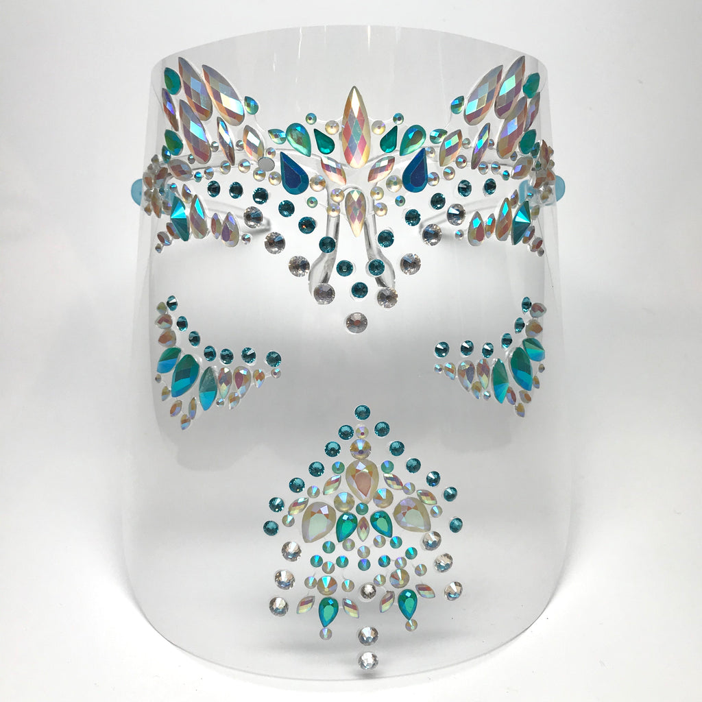 Clear plastic face shield with pearlescent white and blue rhinestones and blue crystals. Shield is worn on face with 2 arms that rest on the ears. 