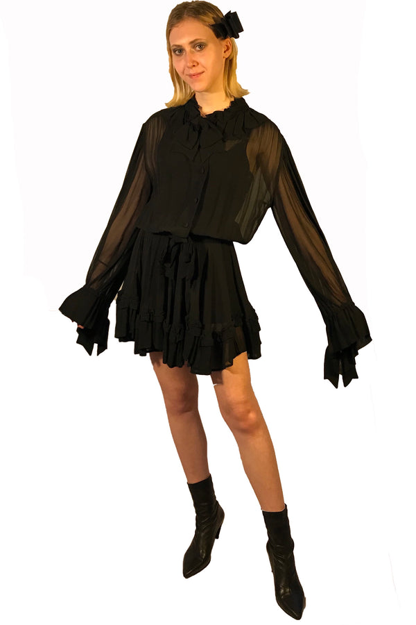 Sheer, long-sleeve, silk dress with bow at neck, and ruffles at wrist. Gathered waist. Length is above the knee.